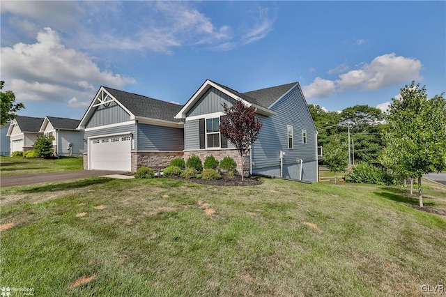 view of front of home with a front yard and a garage