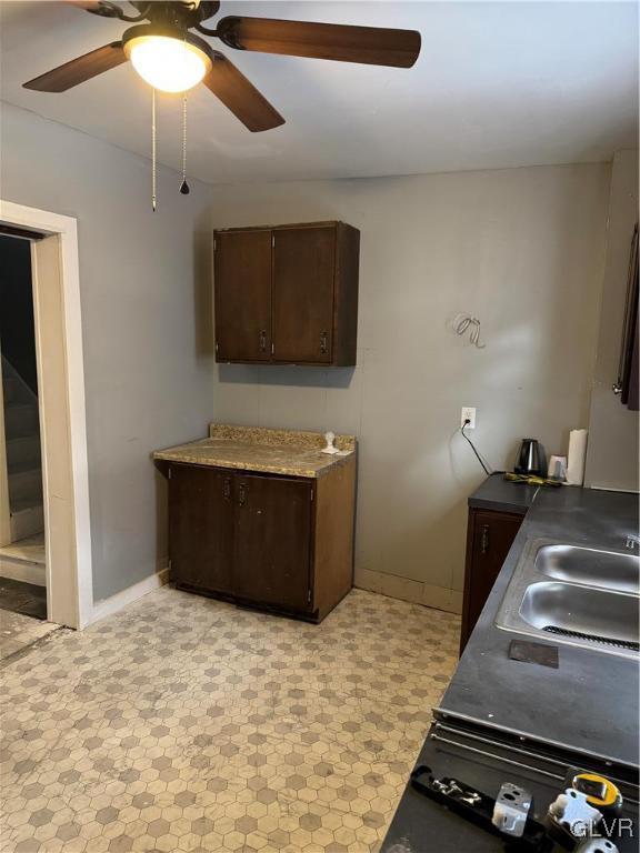 kitchen featuring sink and dark brown cabinetry