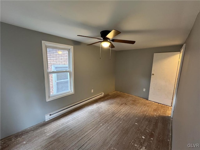 empty room with a baseboard radiator, ceiling fan, and hardwood / wood-style flooring