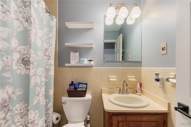 bathroom featuring toilet, tile walls, and vanity