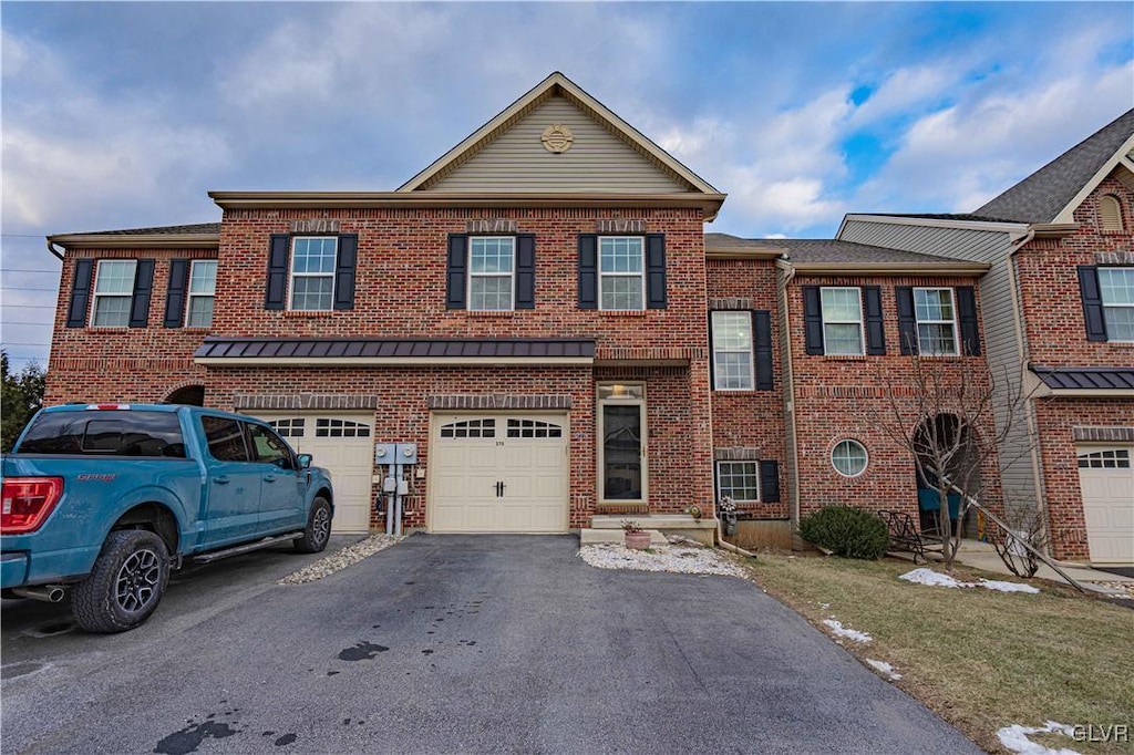 multi unit property featuring a garage