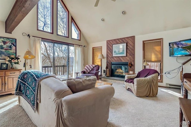 living room with ceiling fan, light colored carpet, a towering ceiling, beamed ceiling, and a baseboard radiator