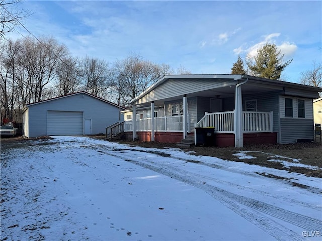 view of front of property featuring a garage, an outdoor structure, and a porch