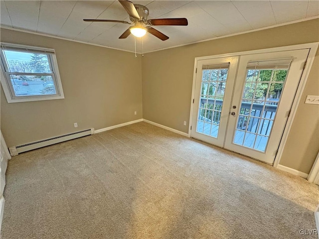 carpeted spare room with ceiling fan, a baseboard radiator, ornamental molding, and french doors