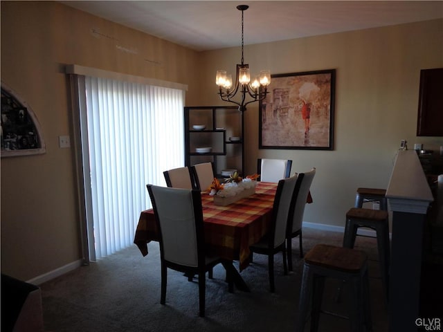 dining room featuring carpet flooring and a chandelier