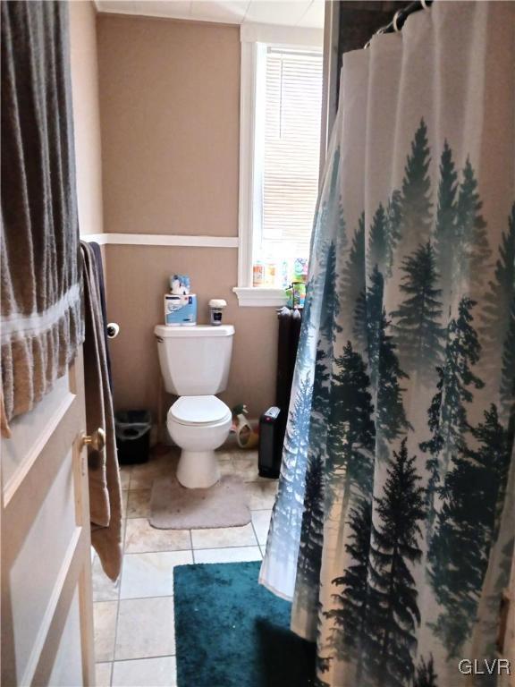 bathroom featuring tile patterned floors and toilet