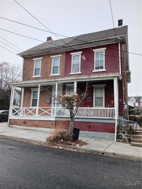 townhome / multi-family property featuring a porch