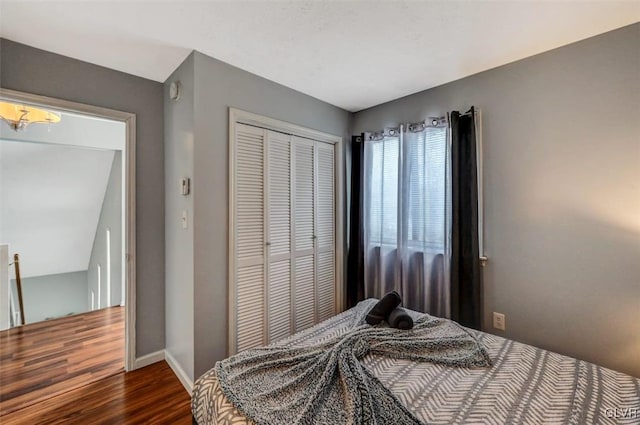 bedroom featuring a closet and dark hardwood / wood-style flooring