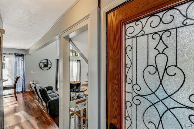 interior details with a textured ceiling and hardwood / wood-style floors