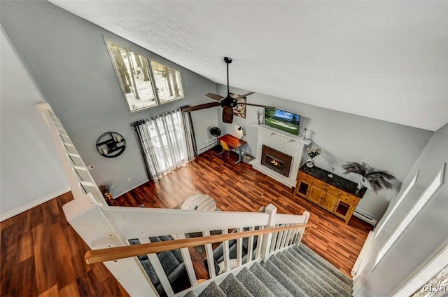 living room featuring ceiling fan, dark hardwood / wood-style floors, and high vaulted ceiling