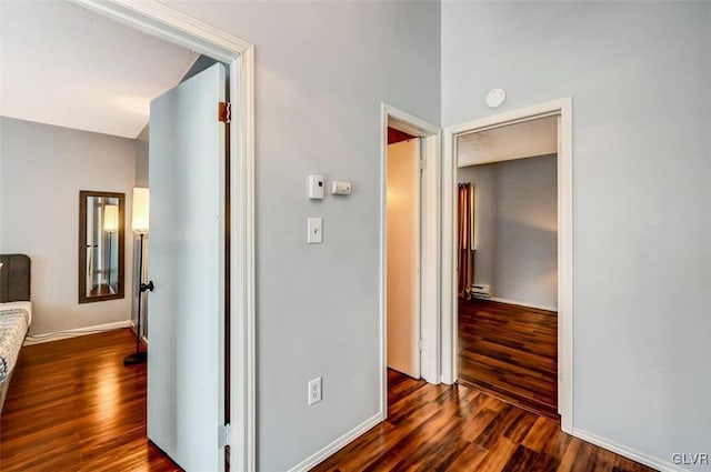 hall featuring baseboard heating and dark wood-type flooring