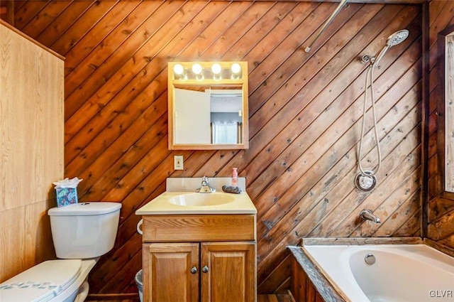 bathroom with toilet, vanity, and wood walls