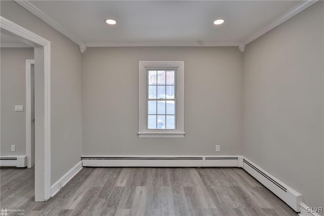 unfurnished room featuring a baseboard heating unit, ornamental molding, and light hardwood / wood-style flooring