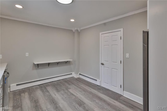 interior space featuring crown molding and light hardwood / wood-style flooring