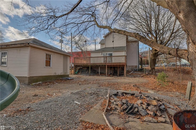 back of house featuring a deck