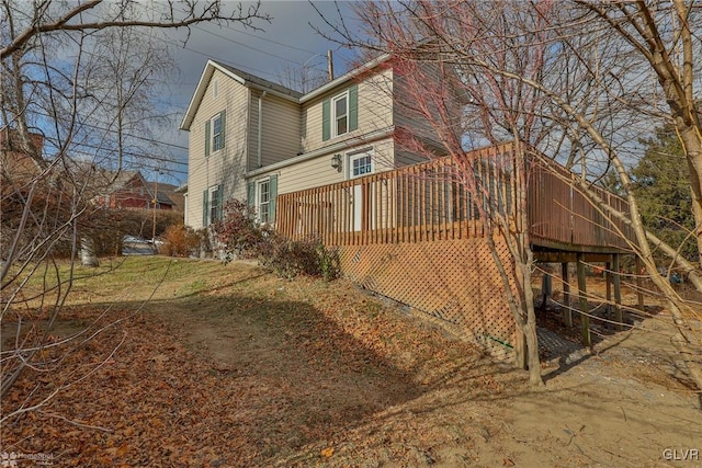 view of side of home with a wooden deck