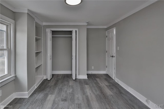 unfurnished bedroom with crown molding and dark hardwood / wood-style floors