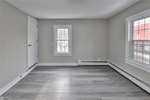 empty room with a baseboard radiator and wood-type flooring