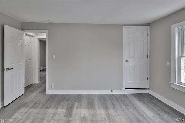 spare room featuring light hardwood / wood-style flooring