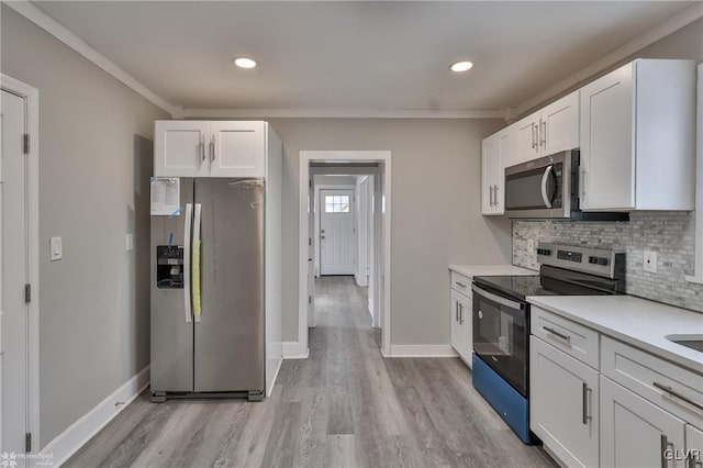 kitchen featuring appliances with stainless steel finishes, decorative backsplash, ornamental molding, and white cabinetry