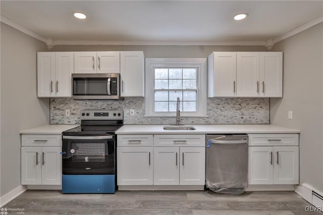 kitchen featuring white cabinets, appliances with stainless steel finishes, and sink