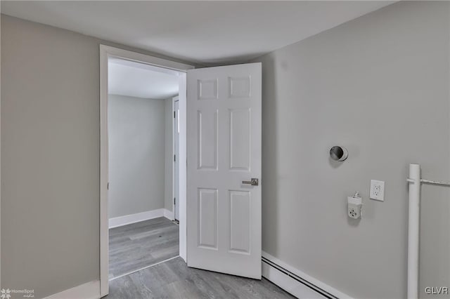 interior space featuring a baseboard radiator and hardwood / wood-style floors