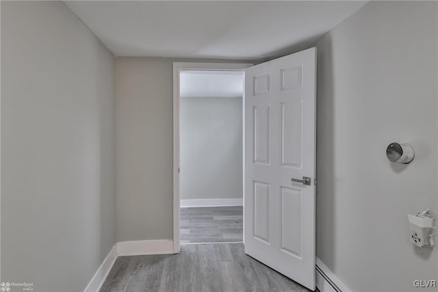 corridor with light hardwood / wood-style floors