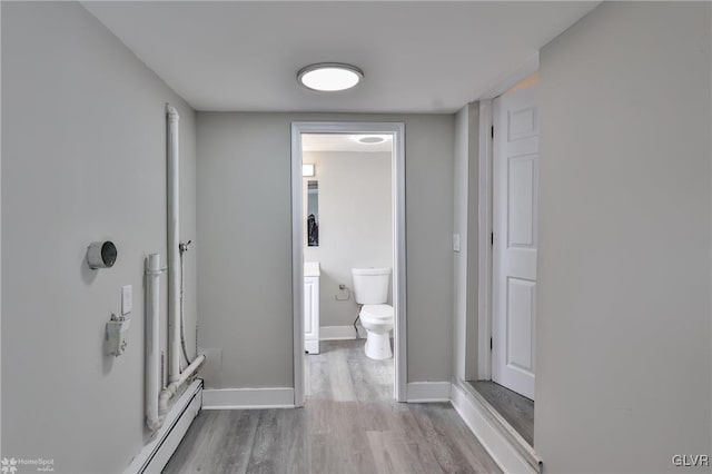 corridor with light hardwood / wood-style floors