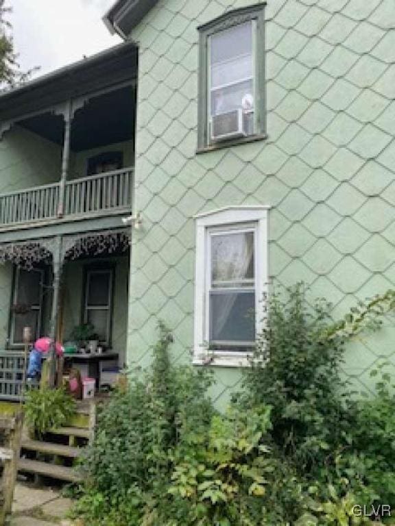 view of home's exterior with cooling unit and a balcony