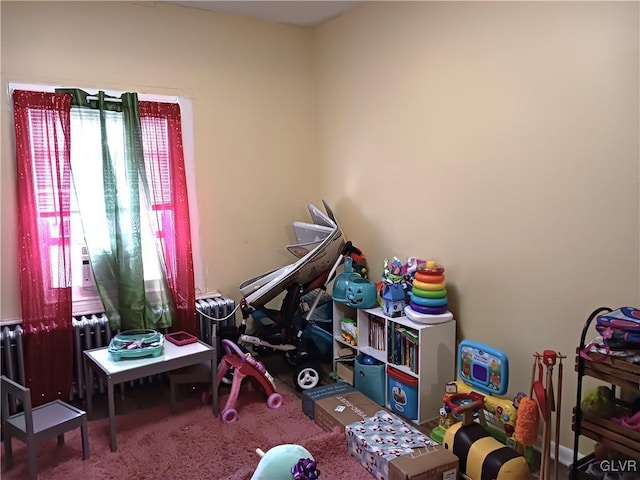 game room featuring radiator and carpet floors