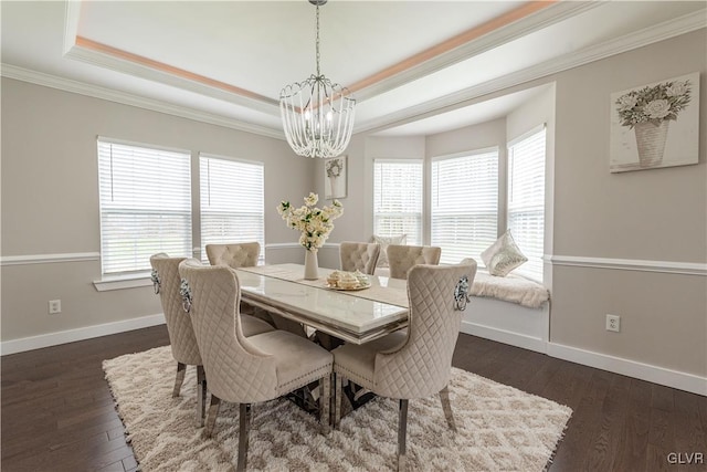 dining space with dark hardwood / wood-style flooring, ornamental molding, and a raised ceiling