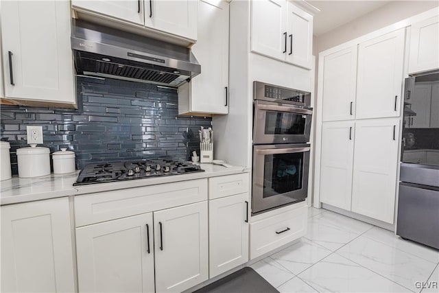 kitchen featuring tasteful backsplash, white cabinets, and stainless steel appliances