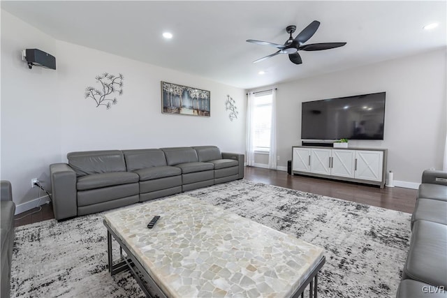 living room featuring ceiling fan and dark hardwood / wood-style floors