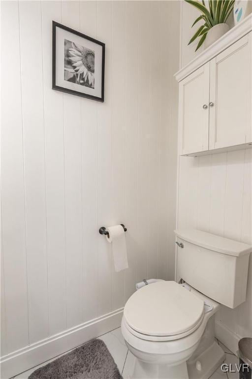 bathroom with toilet and tile patterned flooring