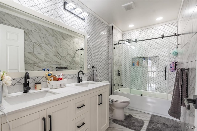 full bathroom with toilet, ornamental molding, vanity, and shower / bath combination with glass door