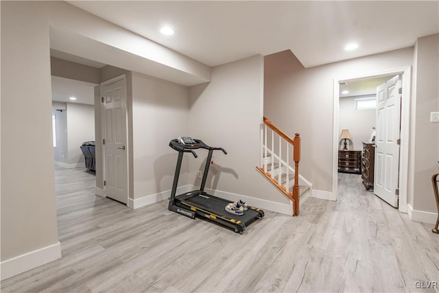 workout room with light hardwood / wood-style floors