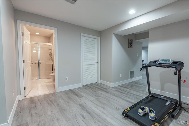 workout area with light hardwood / wood-style floors