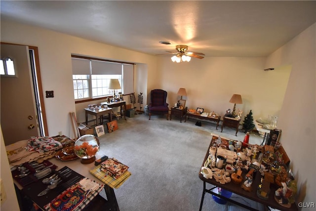 living room featuring carpet and ceiling fan