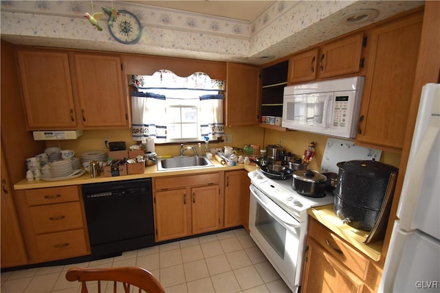 kitchen featuring sink, white appliances, and light tile patterned flooring