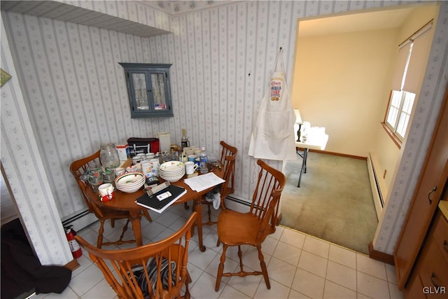 tiled dining room featuring a baseboard heating unit