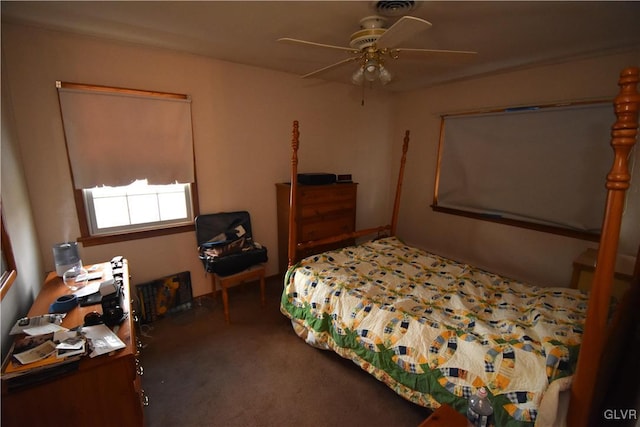 bedroom with ceiling fan and dark carpet