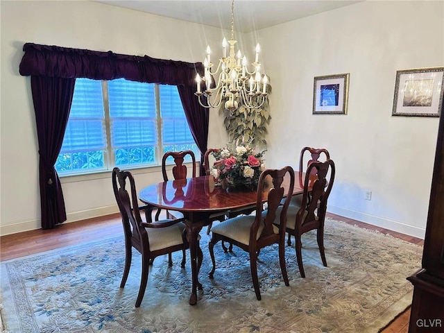 dining room featuring hardwood / wood-style floors and a notable chandelier