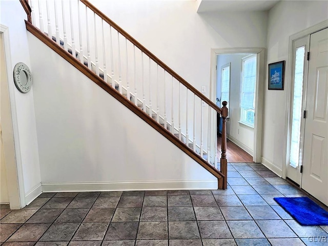 entryway featuring dark tile patterned floors