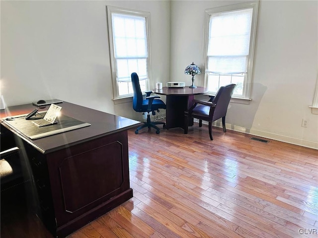 office area with light hardwood / wood-style floors