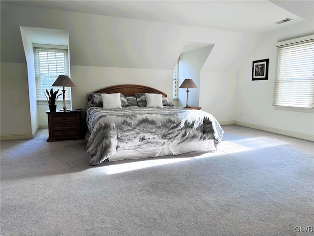 carpeted bedroom featuring lofted ceiling