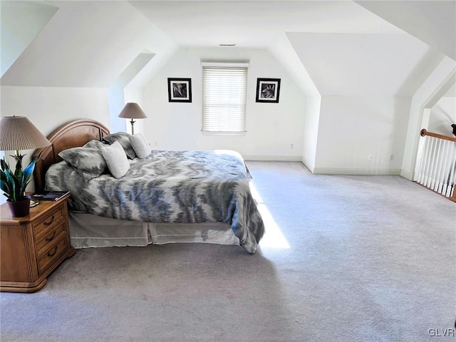 bedroom featuring light colored carpet and vaulted ceiling