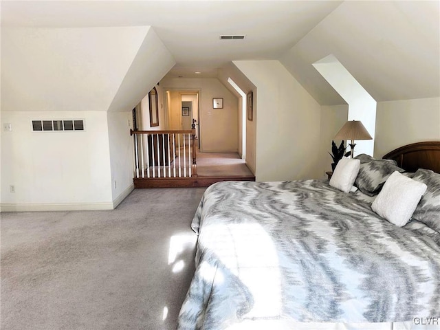 bedroom with vaulted ceiling and light carpet