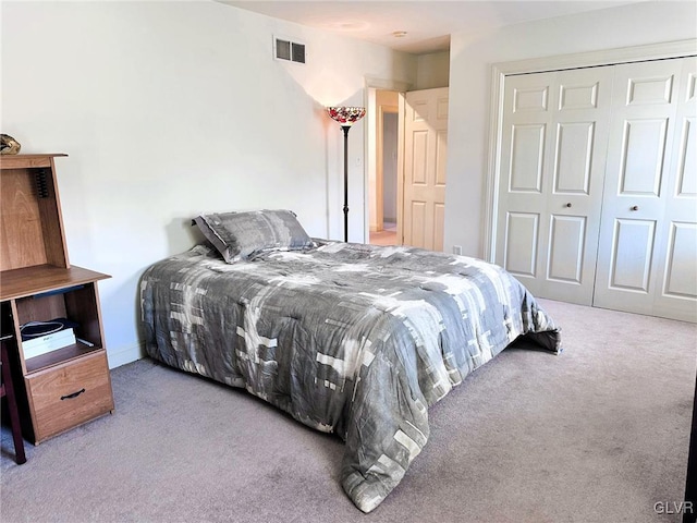 bedroom with light carpet and a closet