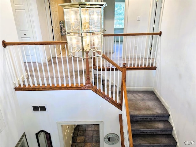 stairs featuring carpet flooring