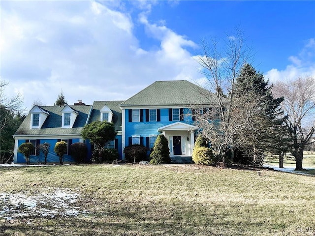 colonial-style house with a front yard